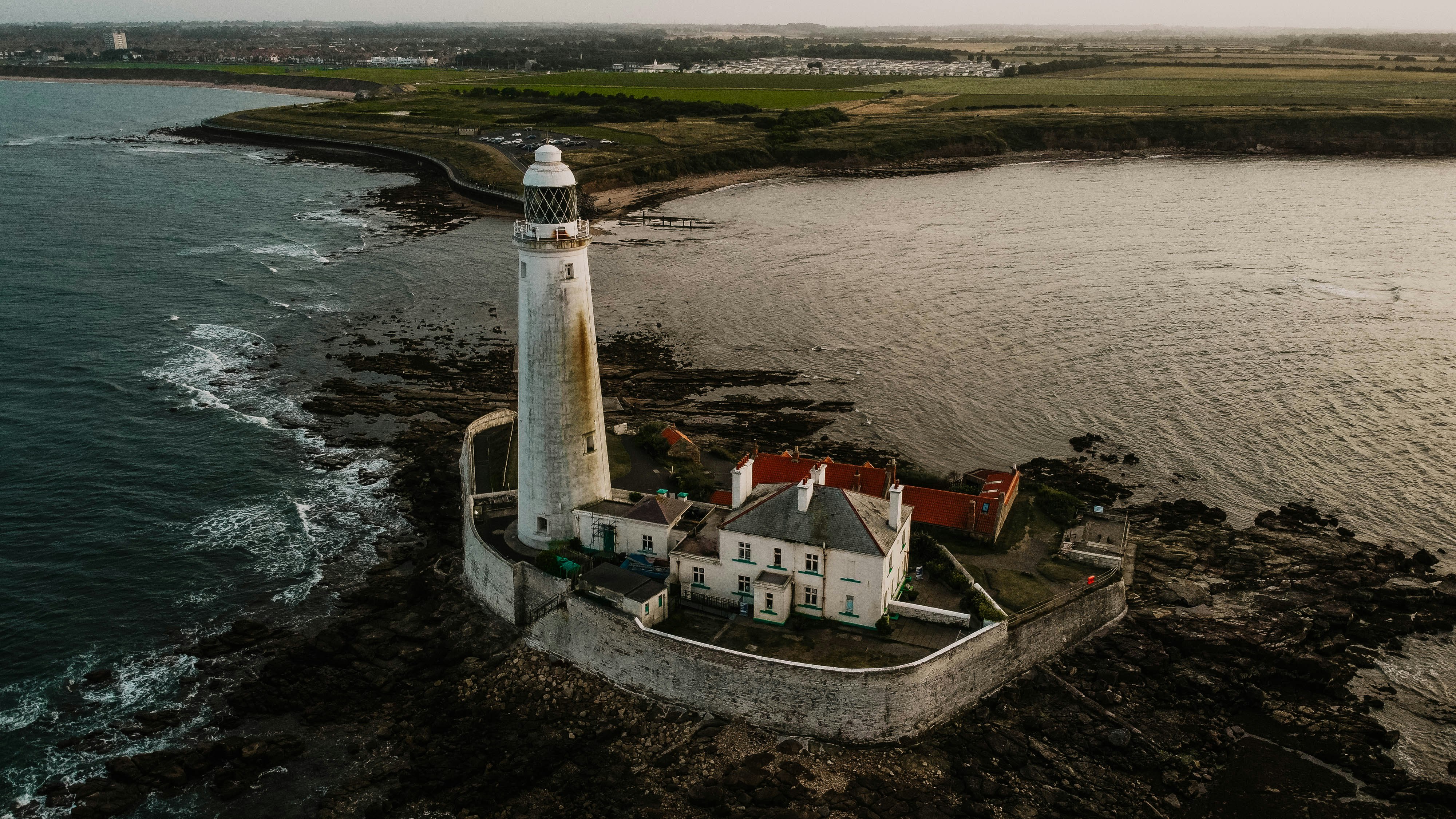 white and brown lighthouse near body of water during daytime